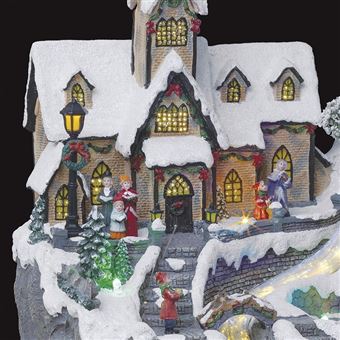 Village de Noël lumineux avec église, maisons, personnages
