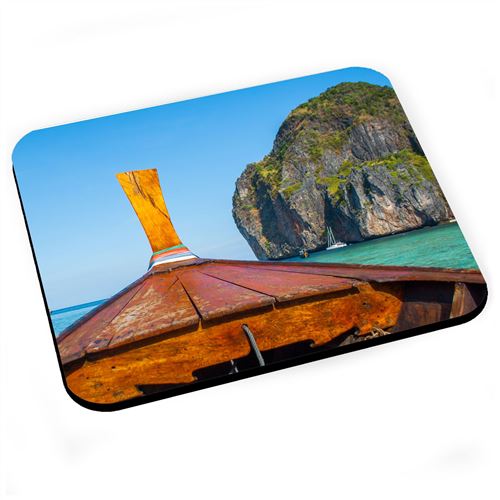 Tapis de souris Vieux bateau de pêche sort d'une crique tropicale
