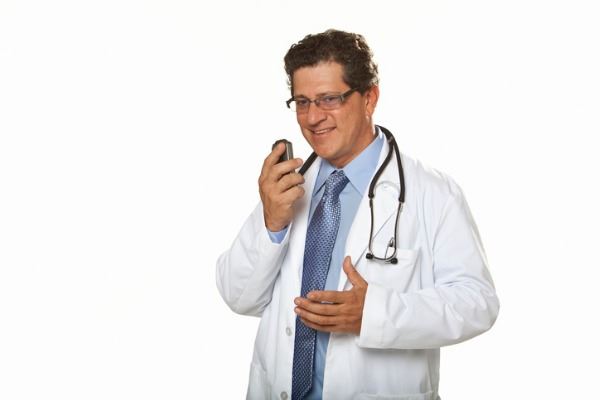 doctor-talking-into-dictaphone-picture-id183828014