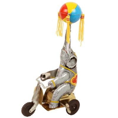 Jouet mécanique Eléphant sur tricycle avec ballon à frange Jouet rétro tôle fer