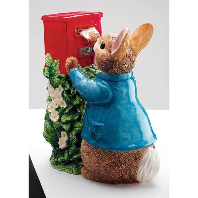 Beatrix Potter Peter Rabbit publiant une tirelire